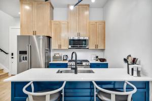 a kitchen with blue cabinets and a stainless steel refrigerator at Queen Bed with Attached Private Bath in Austin