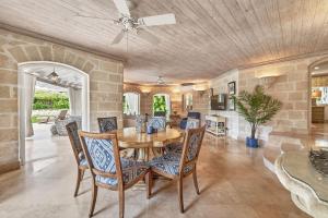 a dining room with a table and chairs at Royal Westmoreland - Villa Grove home in Saint James