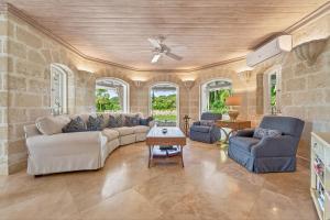 a living room with a couch and chairs and a ceiling at Royal Westmoreland - Villa Grove home in Saint James