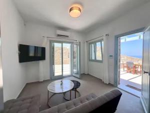 a living room with a couch and a table at Villa House Theasis in Kampos Paros