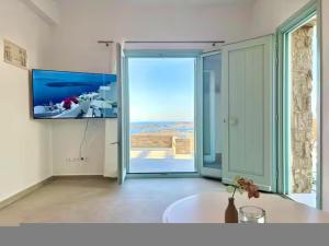 a room with a large sliding glass door with a view at Villa House Theasis in Kampos Paros