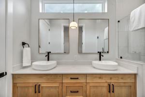 a bathroom with two sinks and a large mirror at Queen Bed with Attached Private Bath in Austin +10 photos