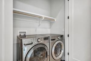 a laundry room with a washer and dryer at Queen Bed with Attached Private Bath in Austin