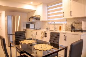 a kitchen with a table and chairs in a kitchen at Oshawa Two Bedroom Private Suite in Oshawa