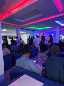 a group of people sitting on blue chairs in a room at Umbrella Properties hotels and apartments - Moniya in Ibadan