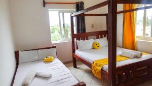 a bedroom with two bunk beds and a window at Breezy hideaway malindi 2br in Malindi
