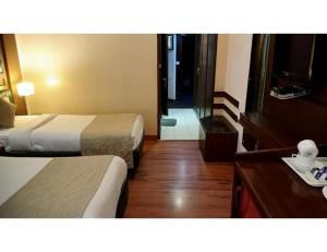 En eller flere senge i et værelse på hotel solitaire