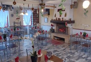 a room with tables and chairs and a fireplace at Le CASTEL 22 in Châteaumeillant +5 photos