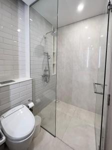 a bathroom with a toilet and a glass shower at casa imobilier in Casablanca