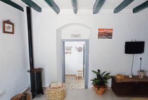 a living room with a fireplace and a tv at Casa Lola in Benaocaz