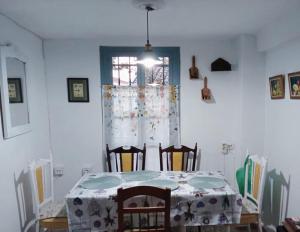 a dining room with a table and chairs and a window at Casa Lola in Benaocaz