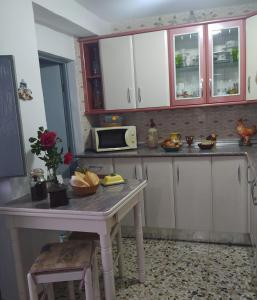 a kitchen with a table and a microwave at Casa Lola in Benaocaz +8 photos