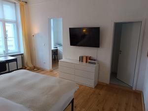 a bedroom with a flat screen tv on a wall at Studio Berlin Center in Berlin