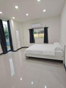 Haru Home Khaoyai في Nong Nam Daeng: غرفة نوم بيضاء مع سرير ونافذة كبيرة