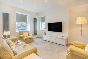 a living room with a couch and a flat screen tv at 4 Bed in Killay oc-c28372 in Killay