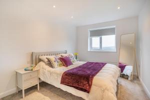 a bedroom with a large bed and a mirror at 4 Bed in Killay oc-c28372 in Killay