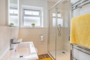 a bathroom with a sink and a shower at 4 Bed in Killay oc-c28372 in Killay +11 photos