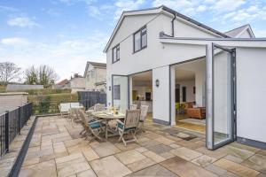 an extension to a house with a patio with a table and chairs at 4 Bed in Killay oc-c28372 in Killay