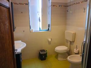 un bagno con un water bianco e un lavandino di Casa Tosca a San Pietro