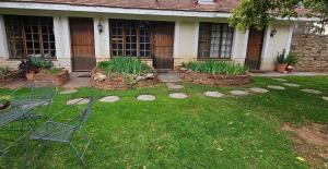 a house with a yard with some plants in it at Home with The Hoffs in Smithfield
