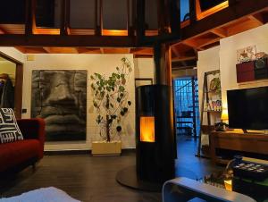 a living room with a couch and a television at Villa West heaven Valley Gent in Ghent