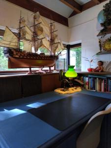 a table with a model of a boat in a room at Villa West heaven Valley Gent in Ghent +79 photos
