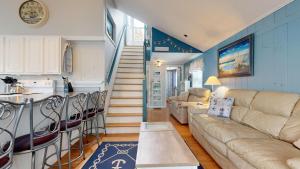 a living room with a couch and a kitchen at Sand Life #2 by Bayley Vacation Rentals in Old Orchard Beach +26 photos