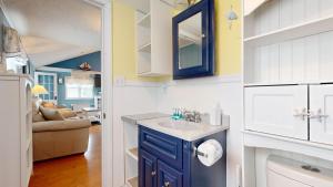 a kitchen with a sink and a blue cabinet at Sand Life #2 by Bayley Vacation Rentals in Old Orchard Beach