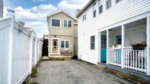 a white house and a white building with a driveway at Sand Life #2 by Bayley Vacation Rentals in Old Orchard Beach