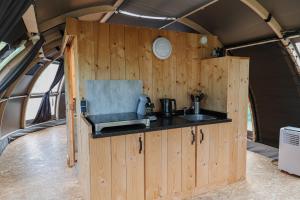 a kitchen with a sink and a counter in a room at Panorama in Hoogersmilde