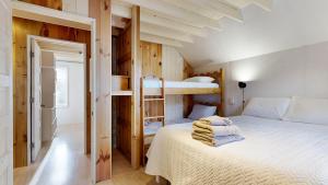 a bedroom with a bed with two bunk beds at Tide & Timber by Bayley Vacation Rentals in Old Orchard Beach