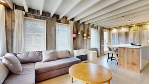 a living room with a couch and a table at Tide & Timber by Bayley Vacation Rentals in Old Orchard Beach +19 photos