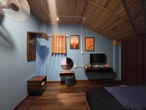 a bedroom with a bed and a desk and a television at Lightning House 2 in Da Lat +44 photos