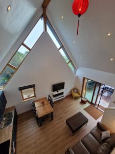 Una vista aérea de una sala de estar con una lámpara de araña. en Black Lodge - Sea view with deck garden, en Garrylucas