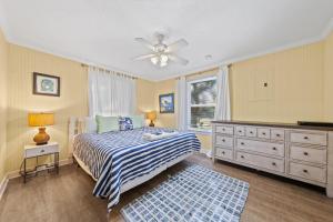 a bedroom with a bed and a ceiling fan at Bay Leave in Gulf Shores