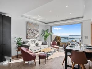 a living room with a couch and a table at Vue Mer - Neuf - Centre Ste Maxime in Sainte-Maxime