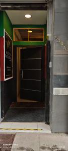 an entrance to a building with a black door at Aventura Patagonica 3 in Punta Arenas