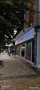a store on a street with people walking in front of it at Aventura Patagonica 3 in Punta Arenas