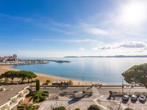a view of a large body of water with cars parked at Vue Mer - Neuf - Centre Ste Maxime in Sainte-Maxime