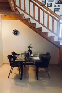 a dining room with a table and two chairs at Meraki - Entire 3BHK Villa With Himalayan Views in Rānīkhet