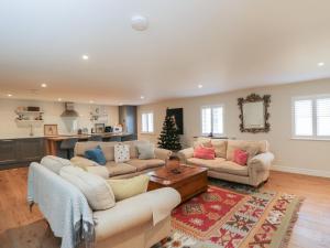 a living room with two couches and a christmas tree at Flat 6 in Tetbury