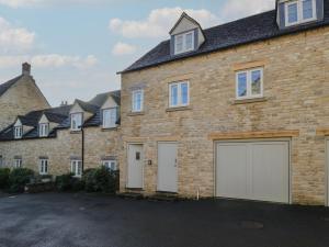 a row of houses with white garage doors at Flat 6 in Tetbury