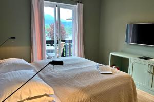 a bedroom with a bed with a laptop on it at Strandhotel Margaretha in St. Wolfgang