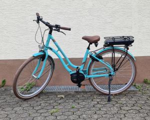 a blue bike parked next to a wall at Hotel - Pension Wendland in Wintrich