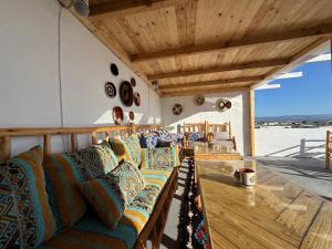 a living room with a couch and a wooden table at Atlantic refuge rooms in Essaouira