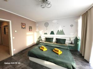 ein Schlafzimmer mit einem grünen Bett mit zwei gelben Kissen in der Unterkunft Große 3-Zimmer Wohnung, zentrale Lage. in Mülheim an der Ruhr