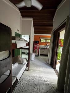 a room with a room with bunk beds in it at Pousada Bromélias in Paraty
