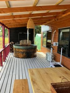 a wooden deck with a hot tub on a house at Chiloé,Curaco de Velez casa de veraneo in Curaco de Velez