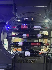 a bunch of wine bottles in a glass case at Glovis Hospitality in Abuja