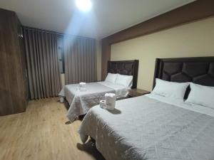 Postel nebo postele na pokoji v ubytování Kapricho Wanka + 8 fotografií